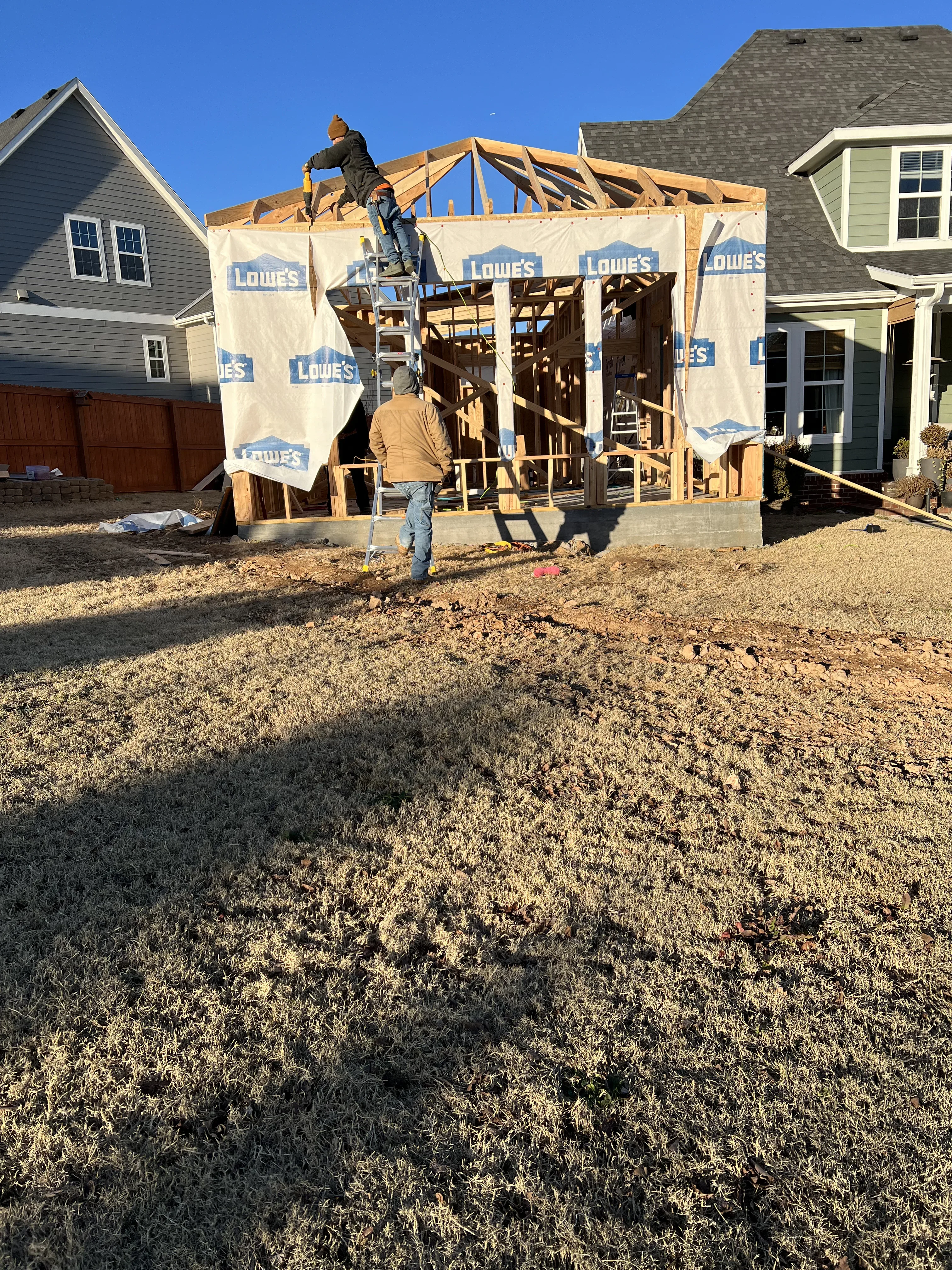 Wood framing and roof trusses for residential room addition under construction